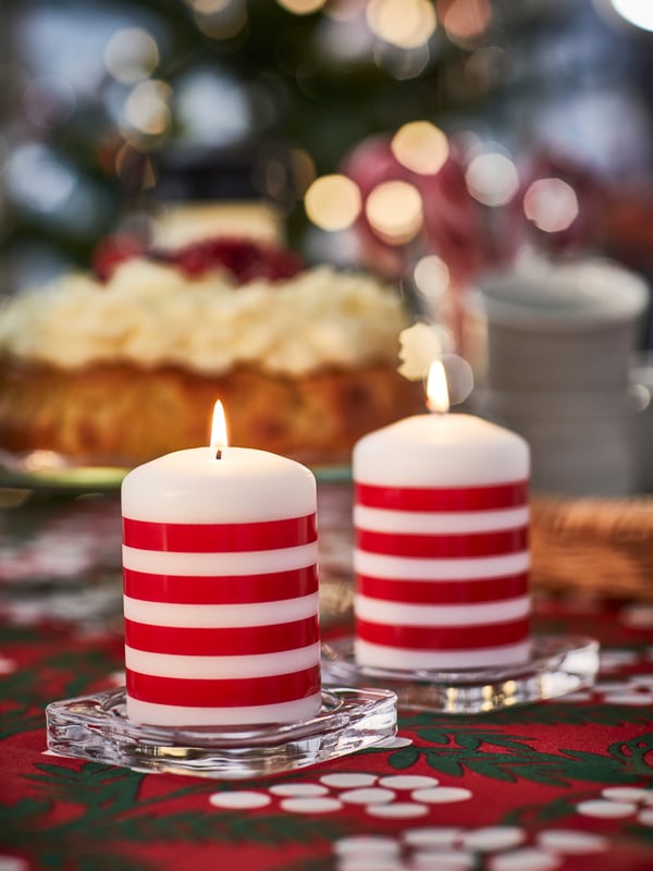 A stripe pattern red/white VINTERFINT unscented pillar candle in the dining room